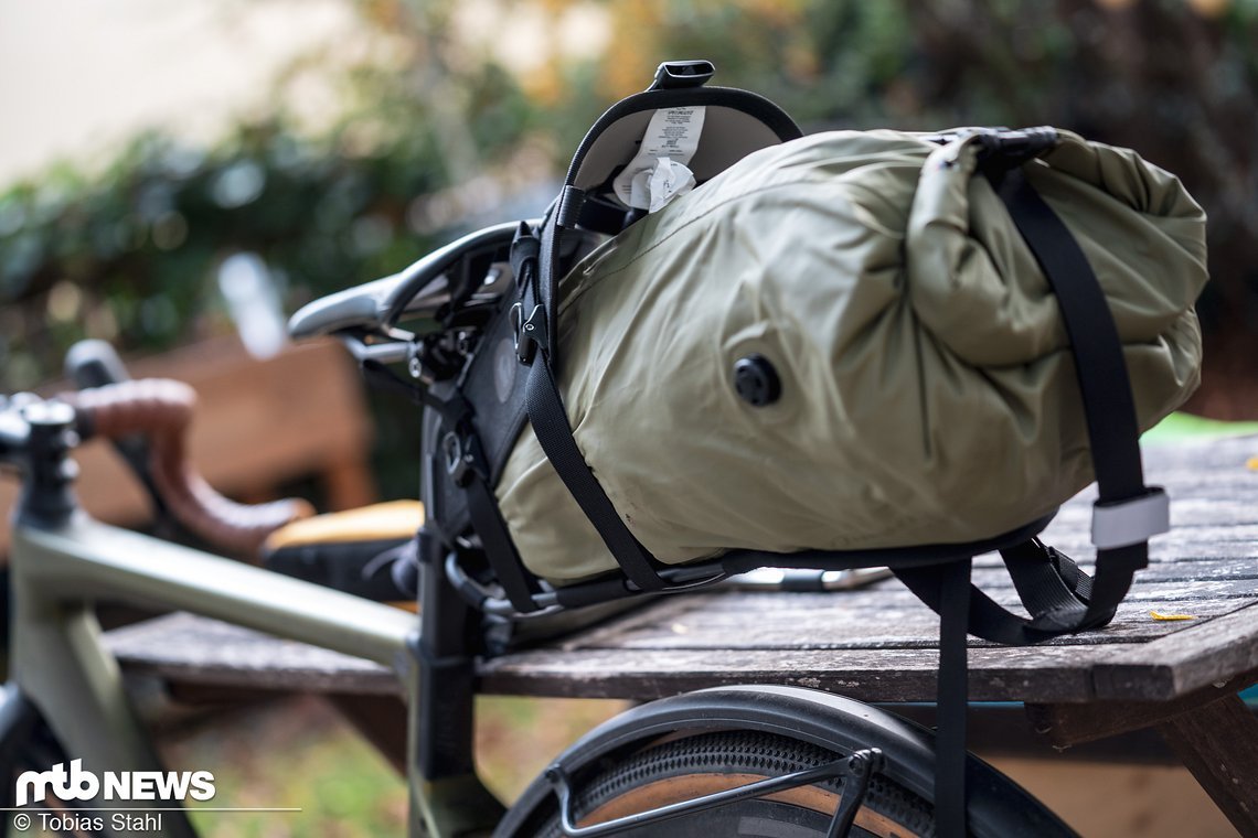 Bei gelösten Spannriemen klappt der Holster auf, so dass der Packsack einfacher eingeschoben werden kann