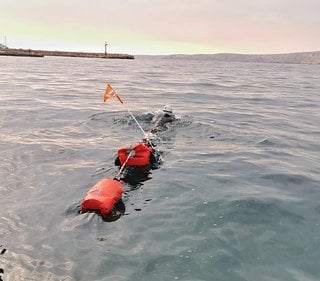 Beim Schwimmen zieht Jonas ein Floß mit seinen Sachen hinter sich her